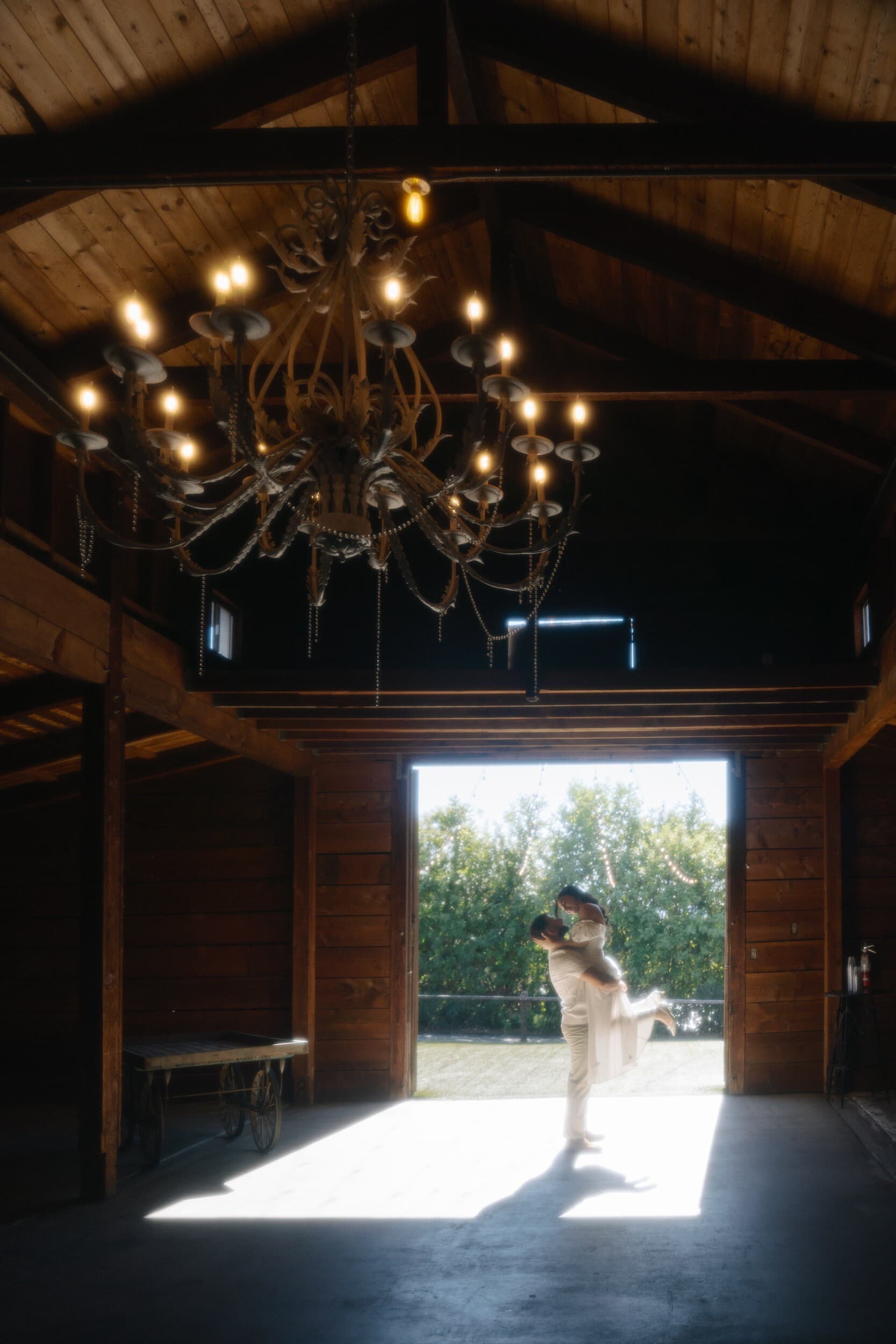 Couple silhouetted in barn doorway