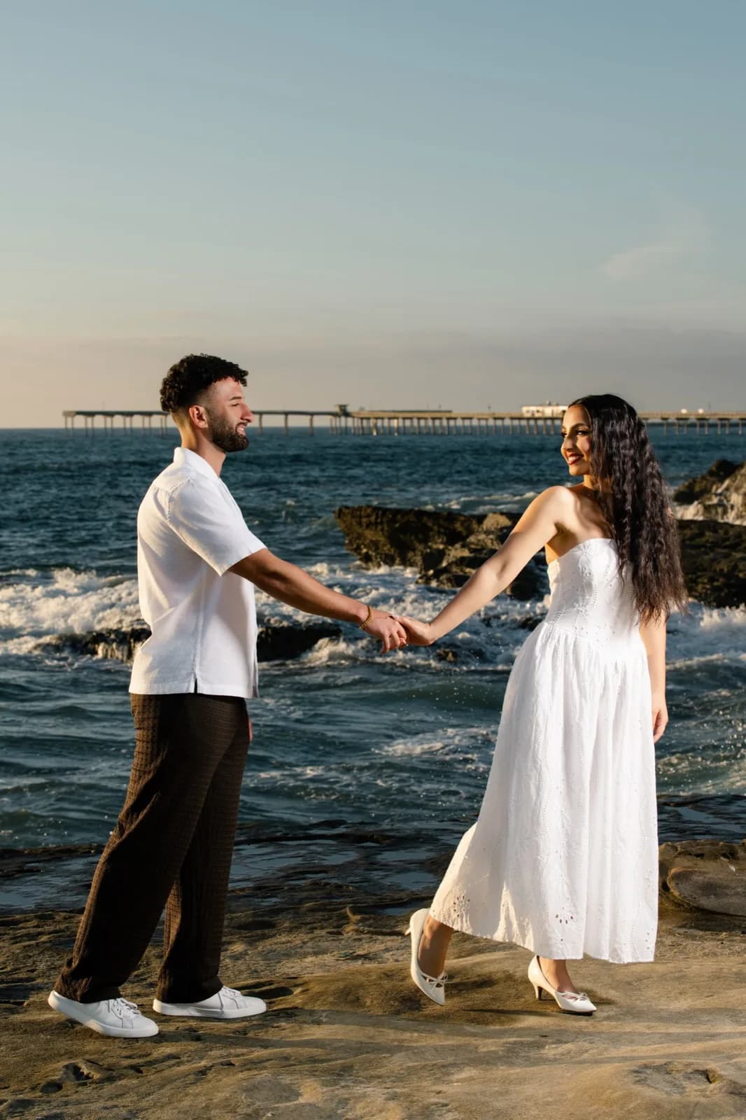 Holding hands on the rocky shore