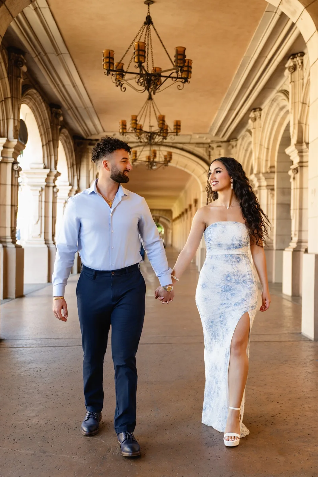 Walking hand in hand under colonnade arches