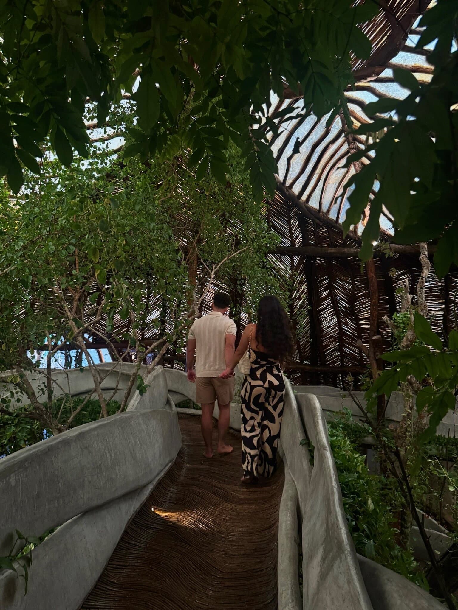 Walking hand in hand through tropical path