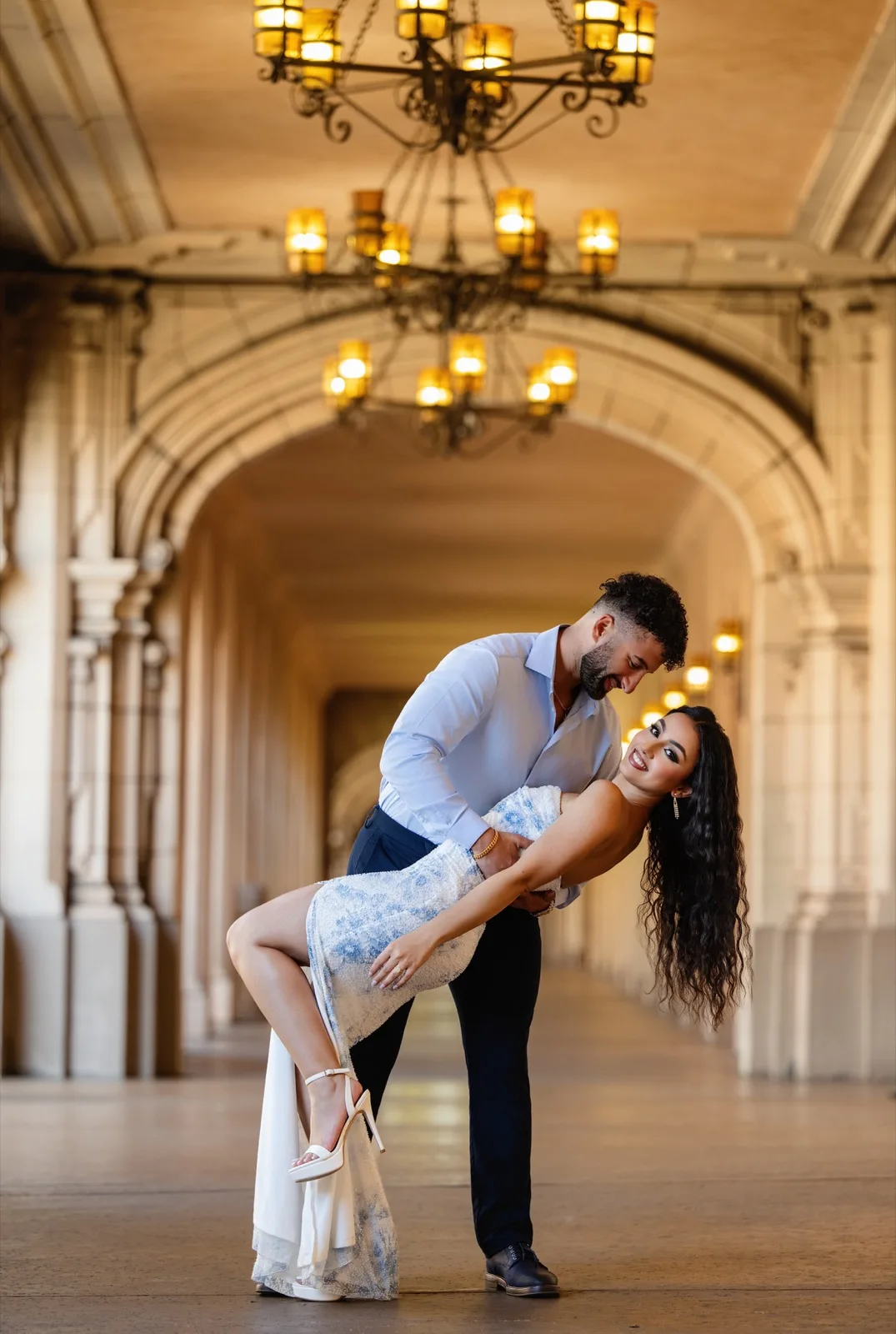 Romantic dip under colonnade chandeliers