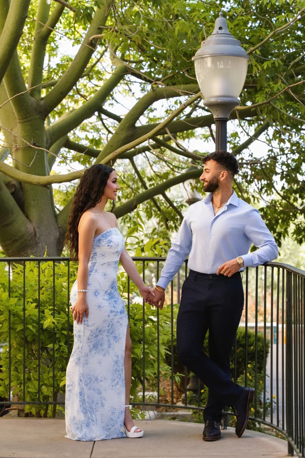 Holding hands by garden railing